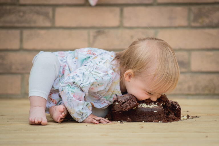 Baby eating a chocolate cake