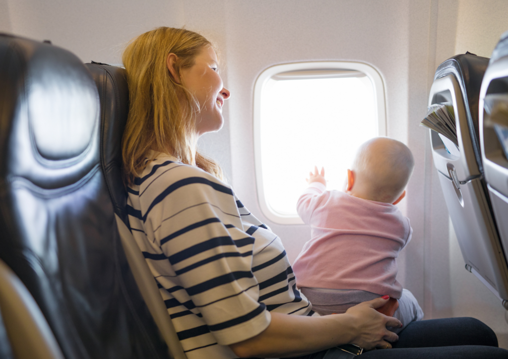 Mum and baby on a plane, looking out of the window