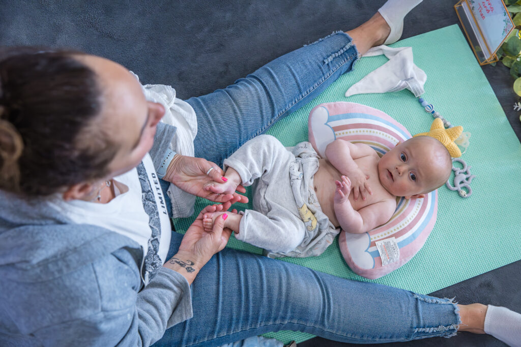 baby being massaged by his mum