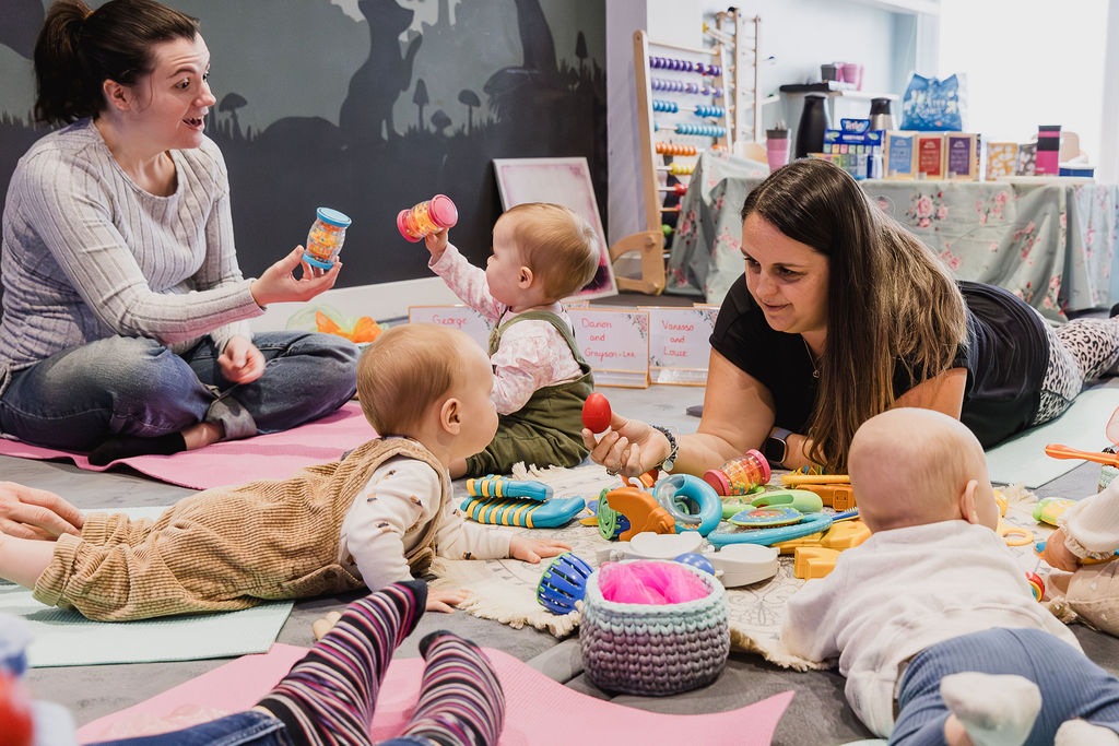 Danielle playing with a baby