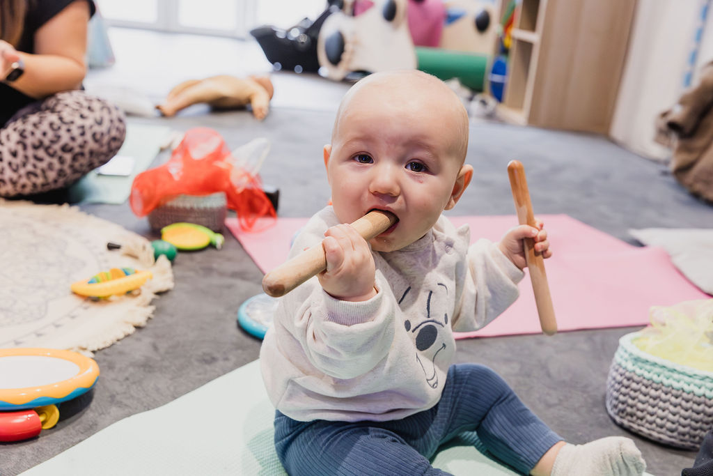 baby playing with tapping sticks
