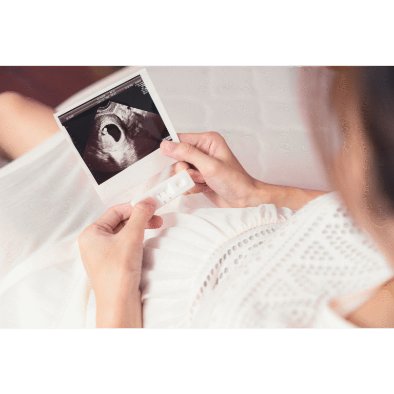 Lady holding a baby scan photo