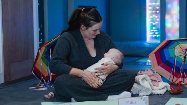 baby asleep in mums arms at class