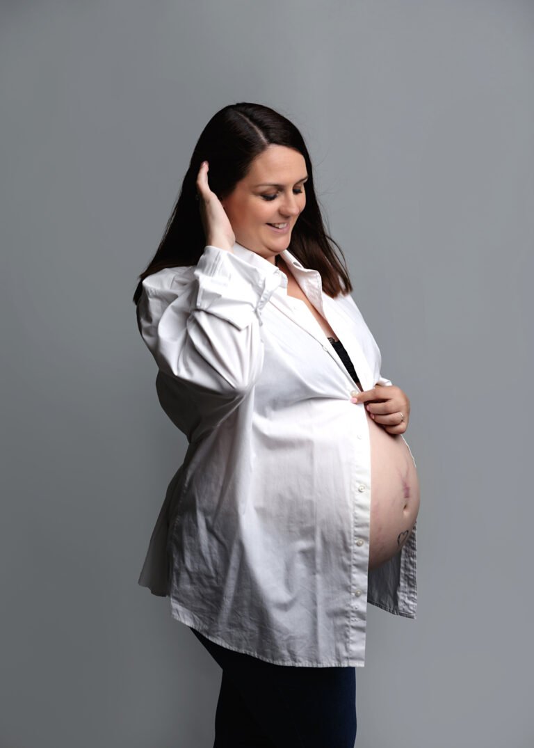 Danielle pregnant in a white shirt